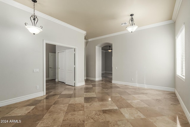 spare room with ceiling fan, ornamental molding, and plenty of natural light