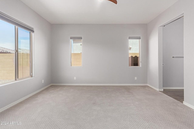 carpeted empty room with baseboards and a healthy amount of sunlight