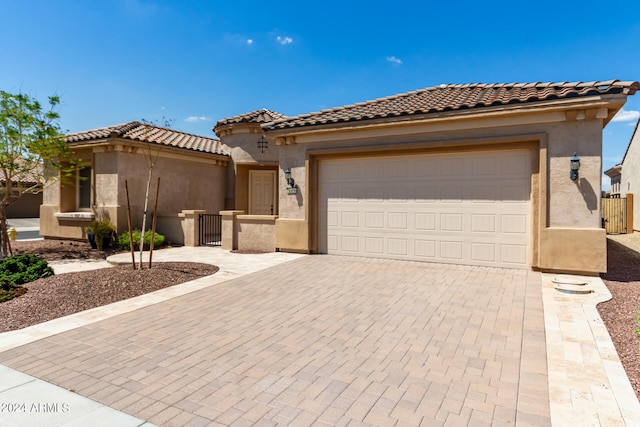 mediterranean / spanish house featuring a garage