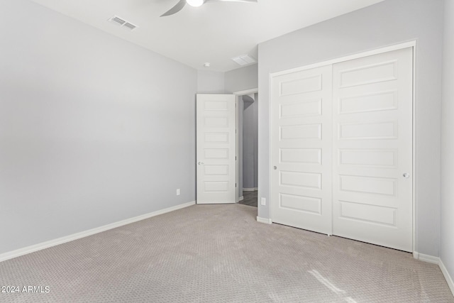 unfurnished bedroom with carpet flooring, a ceiling fan, visible vents, baseboards, and a closet