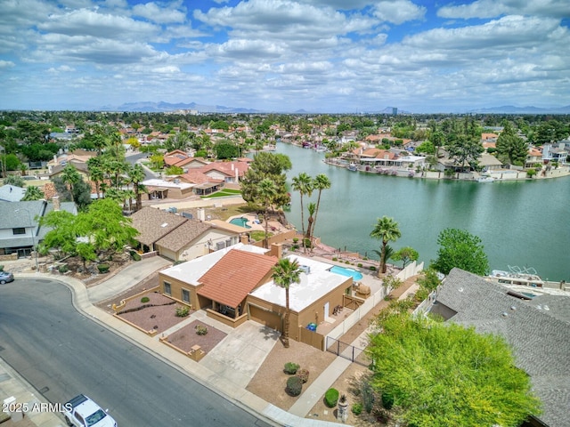 drone / aerial view featuring a water view and a residential view