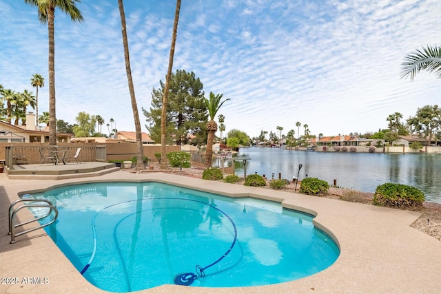 pool featuring a deck with water view and fence