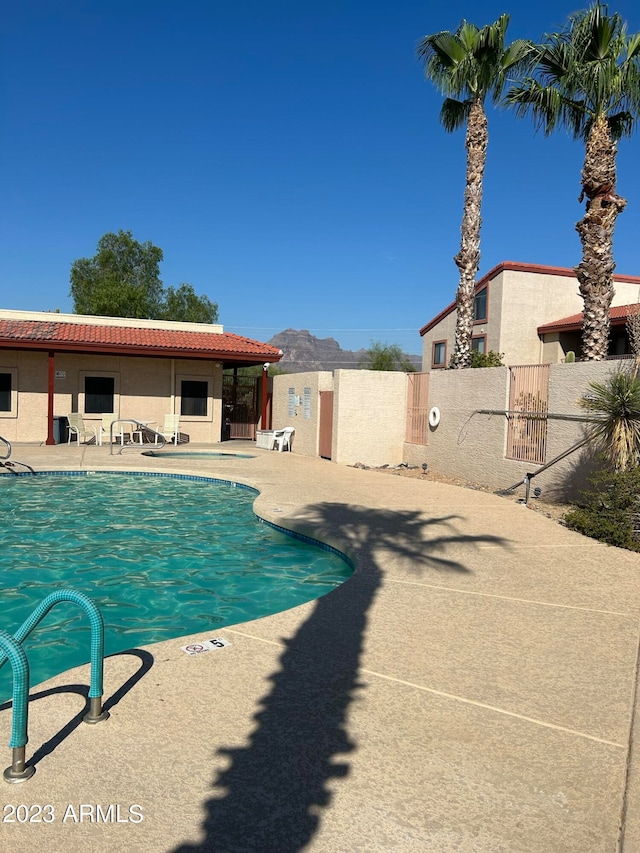 view of pool with a mountain view and a patio area