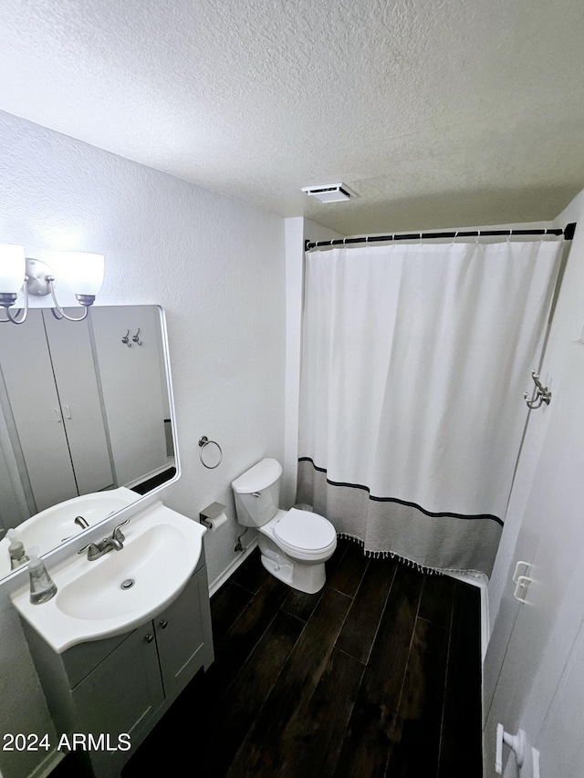 1440 N Idaho Rd Unit 2041, Apache Junction, AZ 85119 - full bathroom featuring a textured ceiling, vanity, wood finished floors, and a shower with shower curtain