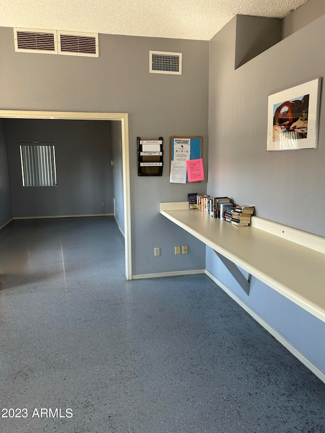 unfurnished office featuring a textured ceiling