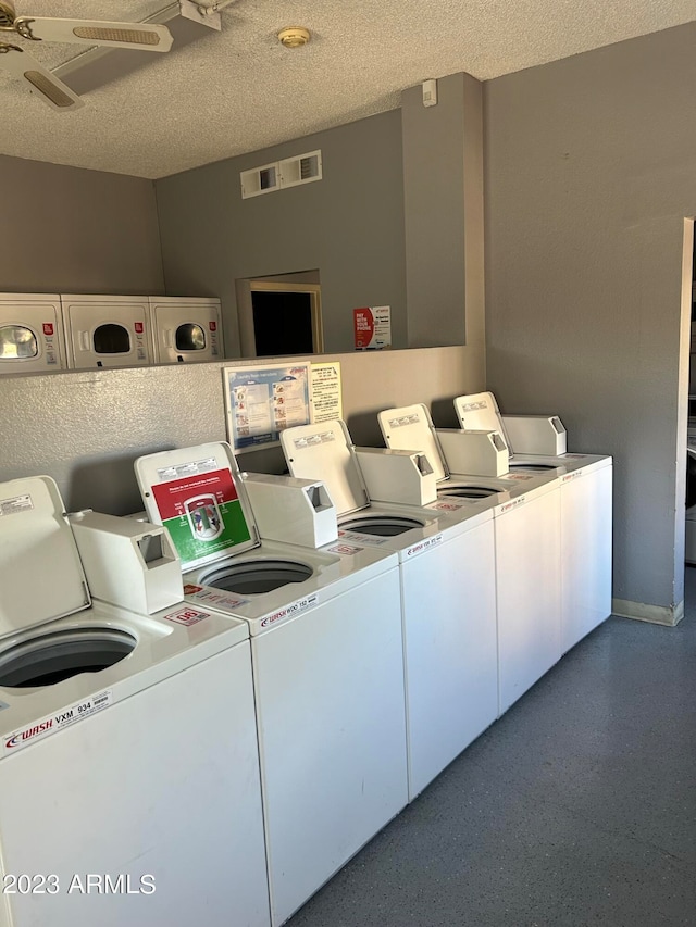 laundry area with a textured ceiling, washer and clothes dryer, and ceiling fan