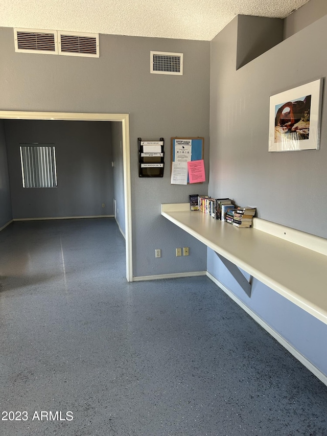 unfurnished office with a textured ceiling