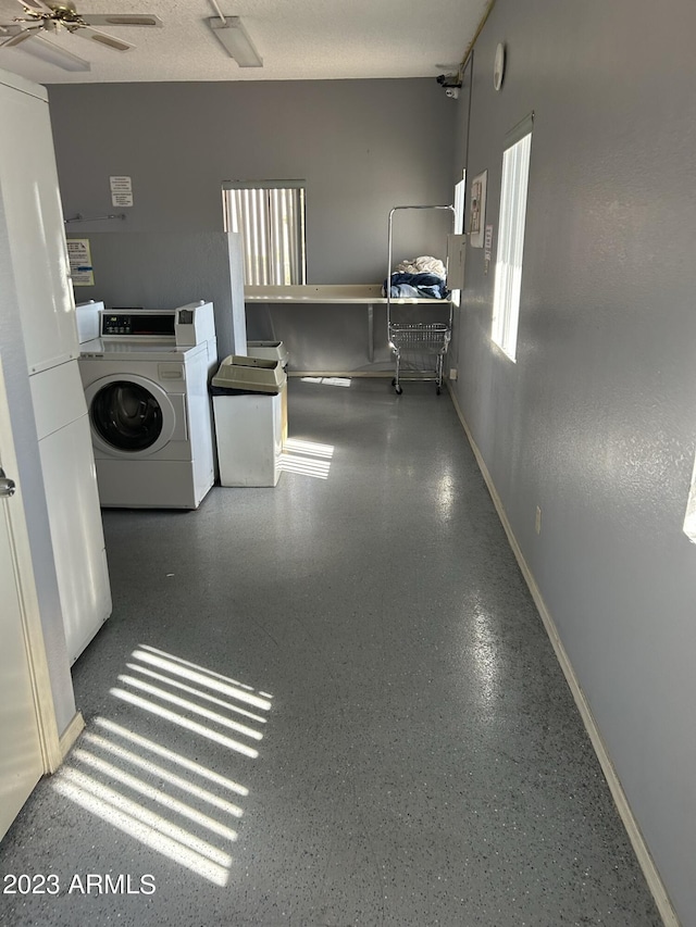 clothes washing area with washing machine and dryer and ceiling fan