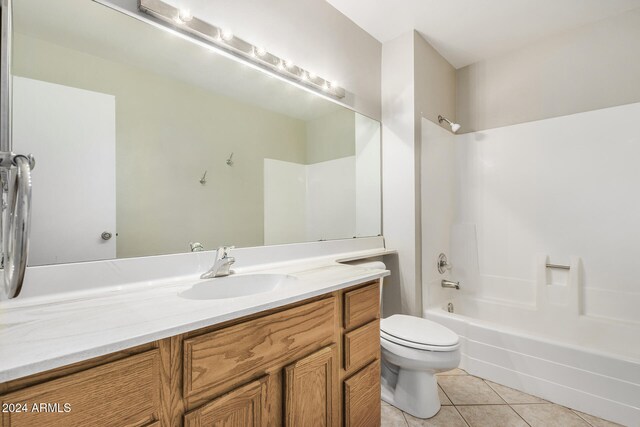 full bathroom featuring tile patterned flooring, vanity, bathtub / shower combination, and toilet