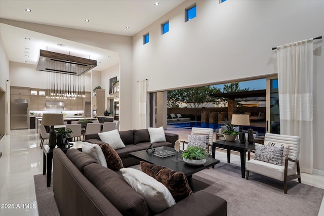 living area with a high ceiling and recessed lighting