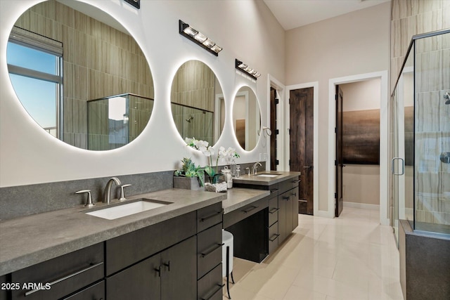 full bath with a stall shower, vanity, and tile patterned floors