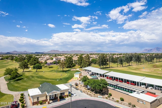 birds eye view of property with a mountain view and view of golf course