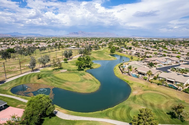 birds eye view of property featuring view of golf course, a residential view, and a water and mountain view