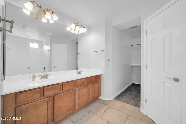 bathroom featuring tile patterned floors, double vanity, visible vents, and a sink