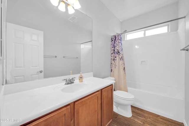 bathroom featuring visible vents, toilet, shower / tub combo with curtain, wood finished floors, and vanity