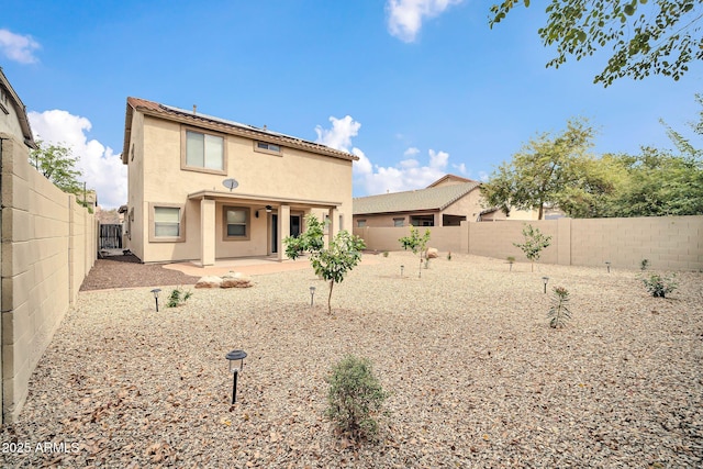 back of house featuring a patio area, a fenced backyard, and stucco siding