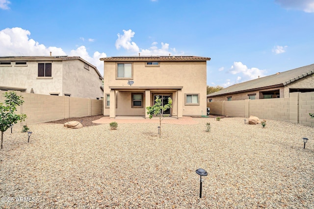 back of house with a patio area, a fenced backyard, and stucco siding