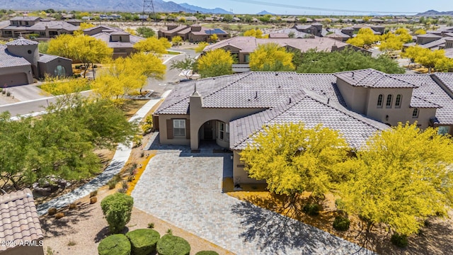 drone / aerial view featuring a residential view and a mountain view