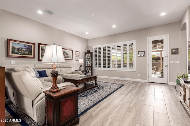 living area featuring baseboards, light wood-type flooring, recessed lighting, and visible vents
