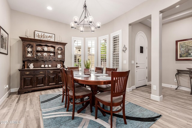 dining room with light wood-style floors, recessed lighting, baseboards, and a chandelier