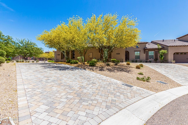 view of front of house featuring stucco siding and a tile roof