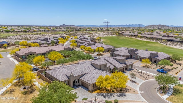 birds eye view of property featuring view of golf course, a residential view, and a mountain view