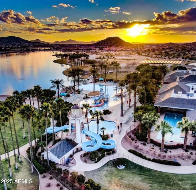 birds eye view of property with a water and mountain view