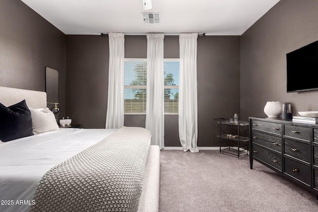 bedroom with visible vents, baseboards, and carpet