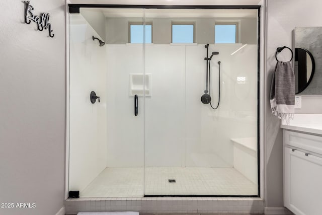 bathroom with a stall shower and vanity
