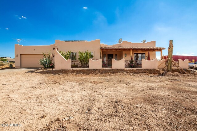 pueblo revival-style home with a garage