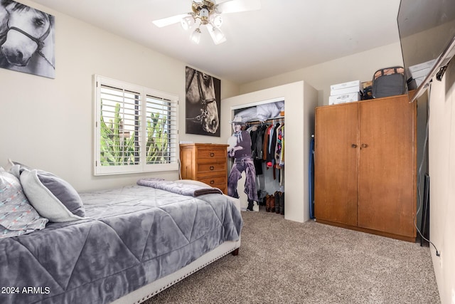 bedroom featuring light colored carpet, a closet, and ceiling fan