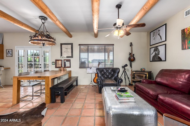 tiled living room with beamed ceiling, a healthy amount of sunlight, ceiling fan, and french doors