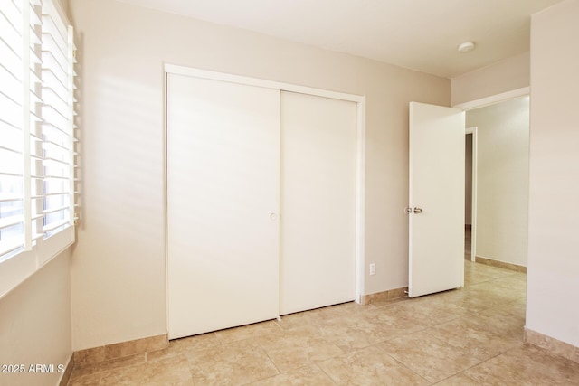 3750 S Conestoga Rd, Apache Junction, AZ 85119 - unfurnished bedroom with a closet and light tile patterned flooring