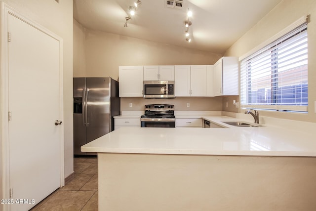 3750 S Conestoga Rd, Apache Junction, AZ 85119 - kitchen featuring stainless steel appliances, light tile patterned floors, light countertops, white cabinets, and a peninsula