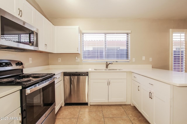 3750 S Conestoga Rd, Apache Junction, AZ 85119 - kitchen featuring stainless steel appliances, light tile patterned floors, a peninsula, white cabinets, and light countertops
