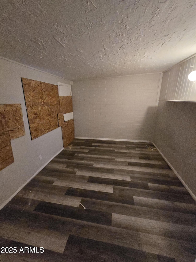 spare room with a textured ceiling and wood finished floors