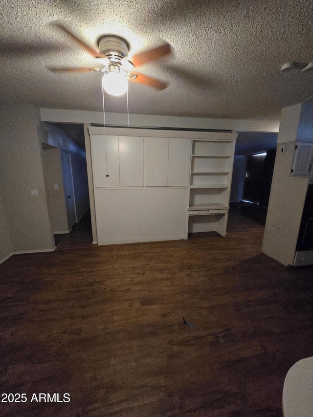 unfurnished bedroom featuring a textured ceiling and dark wood-style flooring