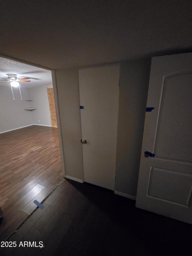 unfurnished room with dark wood-style flooring and ceiling fan