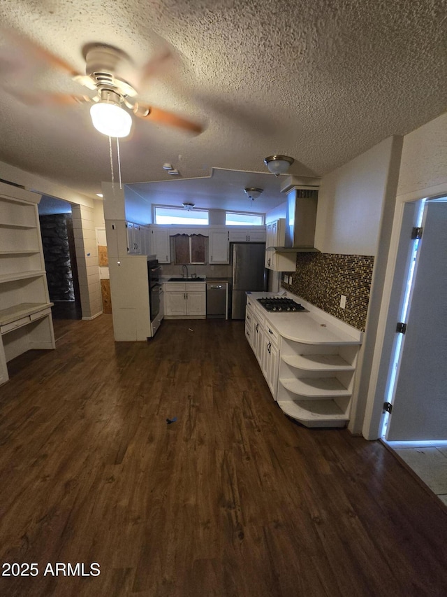 kitchen with stainless steel appliances, dark wood-style flooring, a sink, backsplash, and open shelves