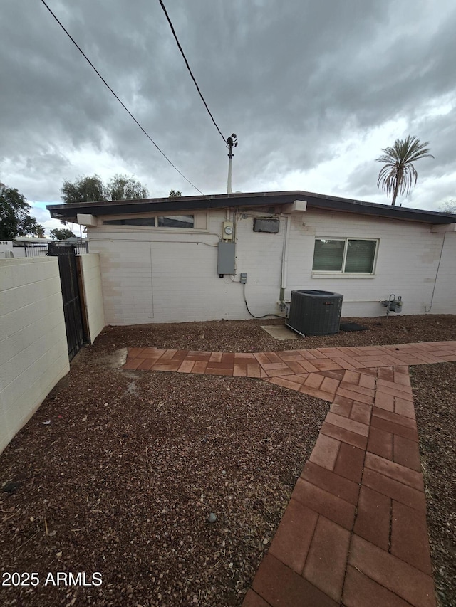 back of house featuring central AC, a patio, and fence