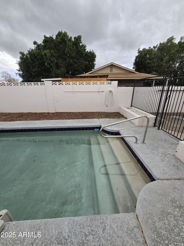 view of swimming pool with a fenced backyard