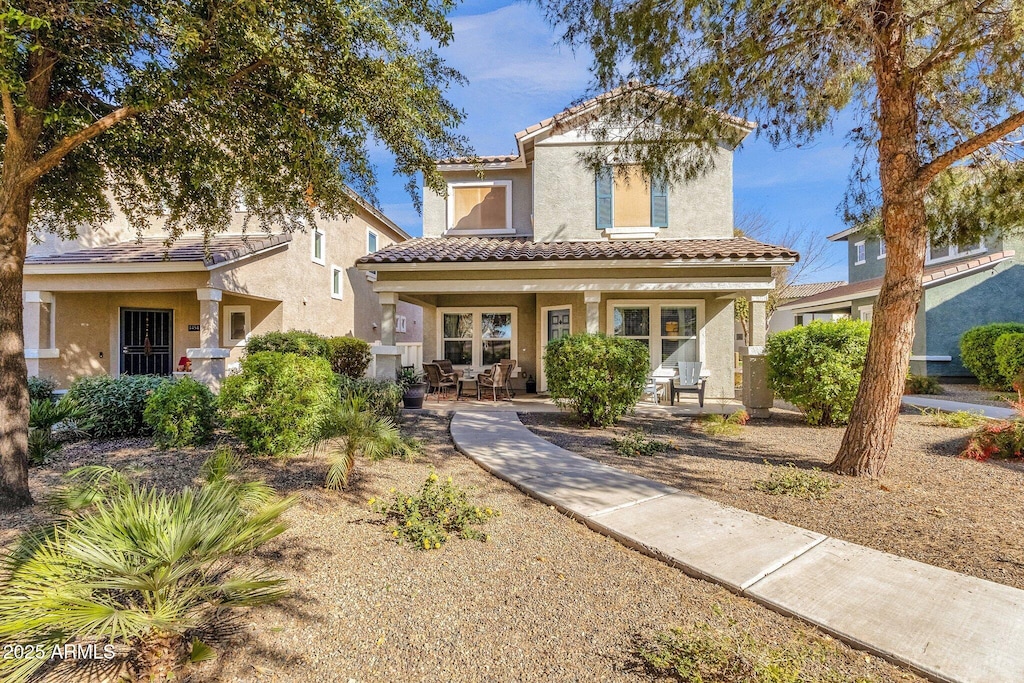 mediterranean / spanish house featuring covered porch