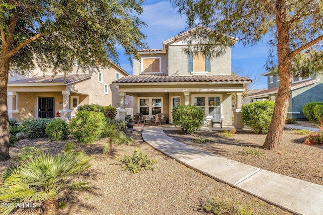 mediterranean / spanish house featuring covered porch