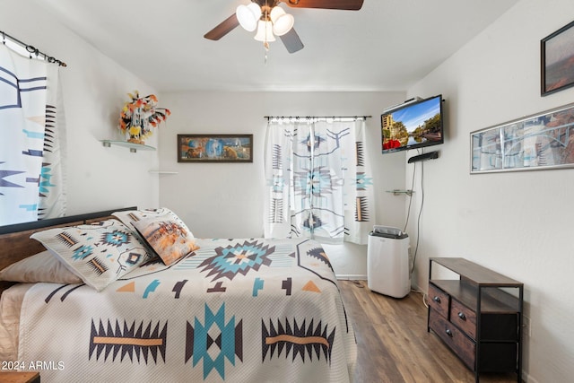 bedroom featuring wood-type flooring and ceiling fan