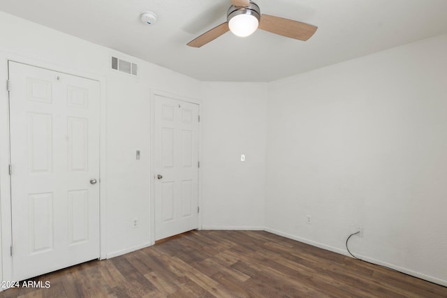 unfurnished bedroom featuring ceiling fan and dark hardwood / wood-style flooring