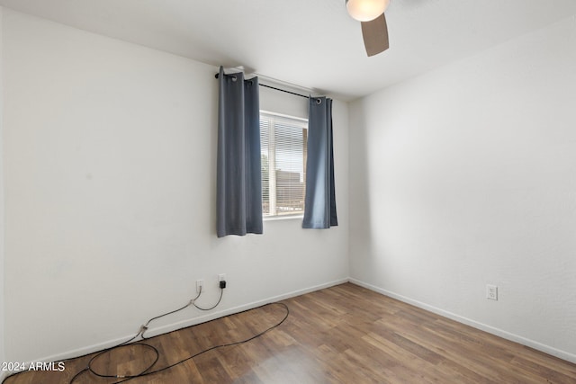 unfurnished room featuring ceiling fan and hardwood / wood-style floors