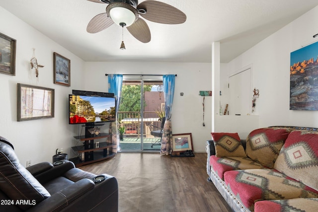 living room with ceiling fan and dark hardwood / wood-style flooring