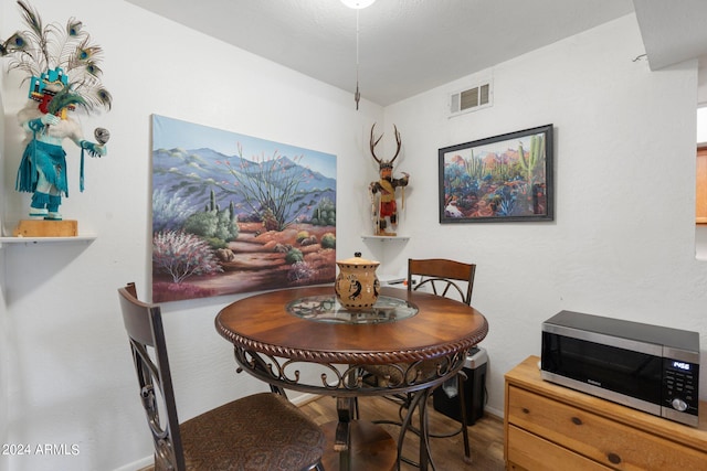 dining space with dark hardwood / wood-style floors