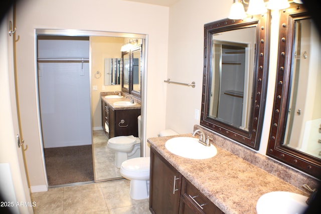 bathroom featuring toilet, tile patterned floors, and vanity