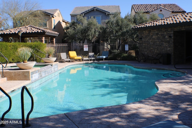 view of swimming pool featuring a hot tub